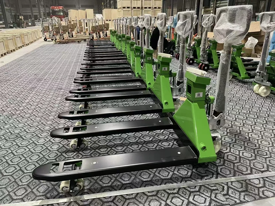 Rows of green and black HENER weighing pallet trucks