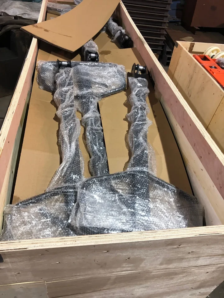 Wrapped pallet truck components protected inside a wooden crate