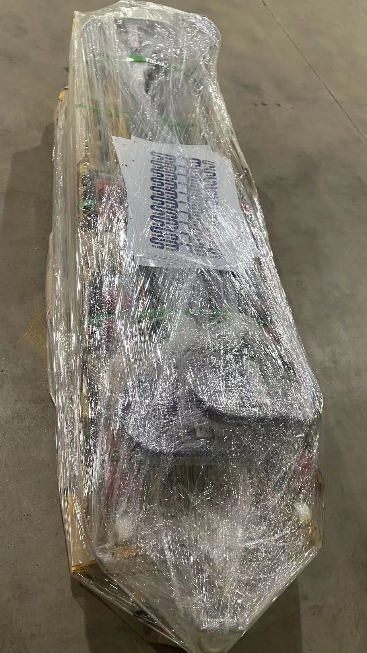Plain manual pallet truck protected with wrapping and securing straps