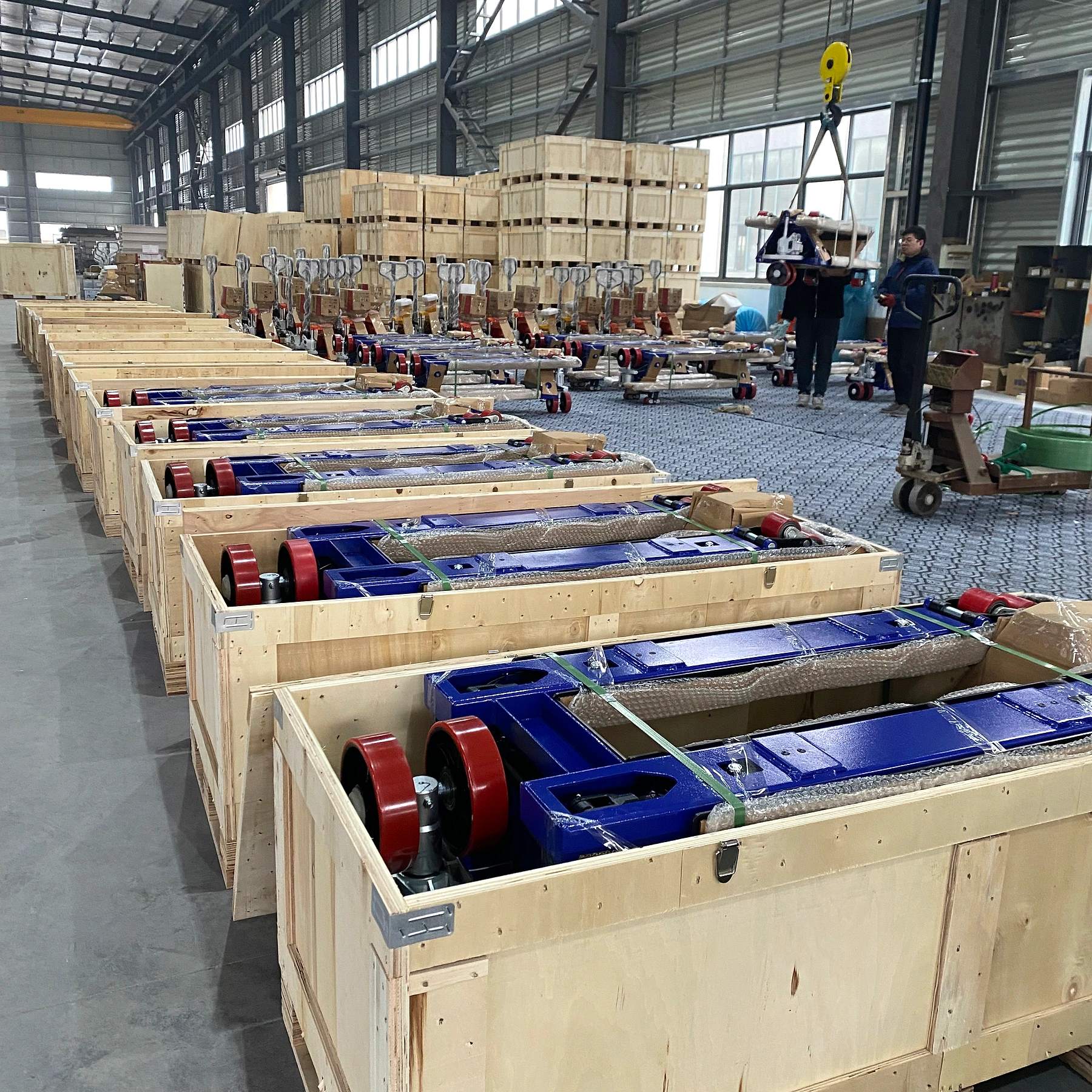 Authentic HENER factory packing area with multiple pallet jack scales secured in wooden export crates