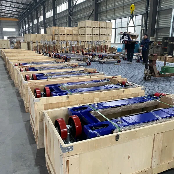 Manual pallet trucks arranged inside open wooden shipping crates